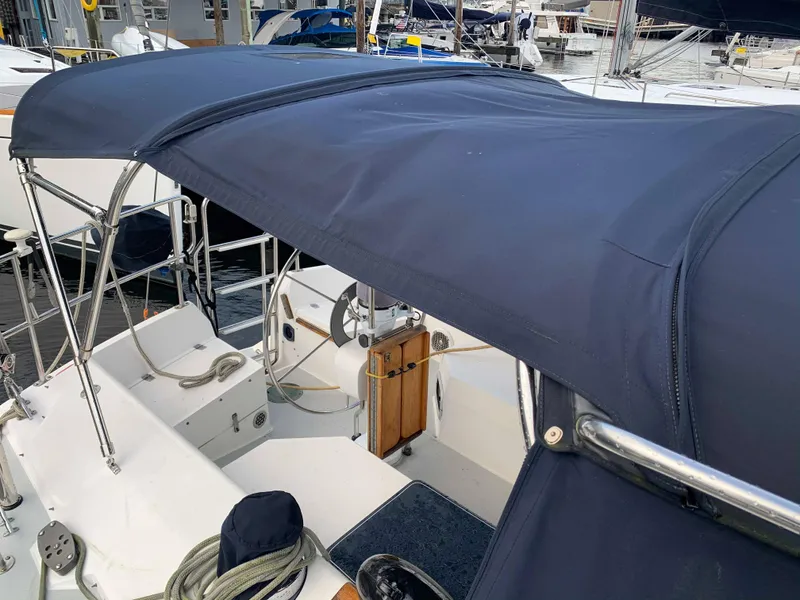 Slide: The Image of 1992 Catalina 42 sailboat with blue cover in marina. - 12