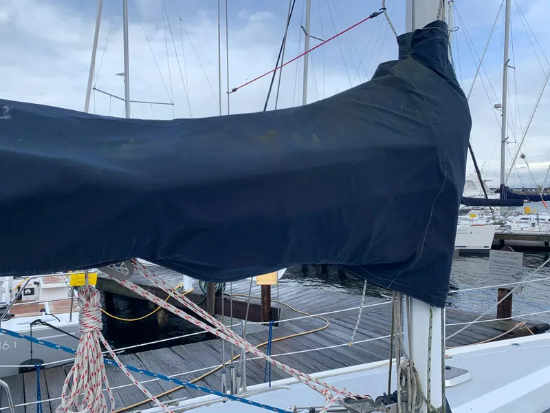 Slide: The Image of 1992 Catalina 42 sailboat with covered mainsail in harbor. - 13