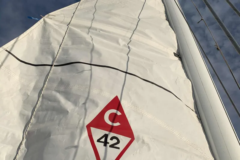 Slide: The Image of 1992 Catalina 42 sailboat with distinctive sail. - 16