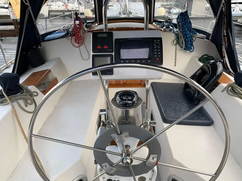 Slide: The Image of Cockpit of a 1992 Catalina 42 sailboat with steering wheel and navigation system. - 17