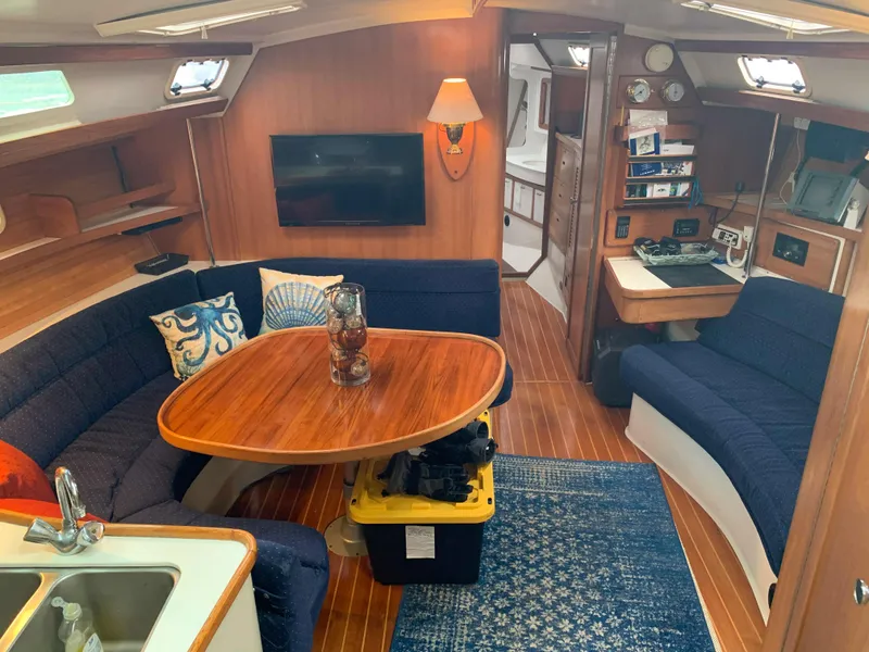 Slide: The Image of Interior of 1992 Catalina 42 sailboat with cozy seating and wooden decor. - 25