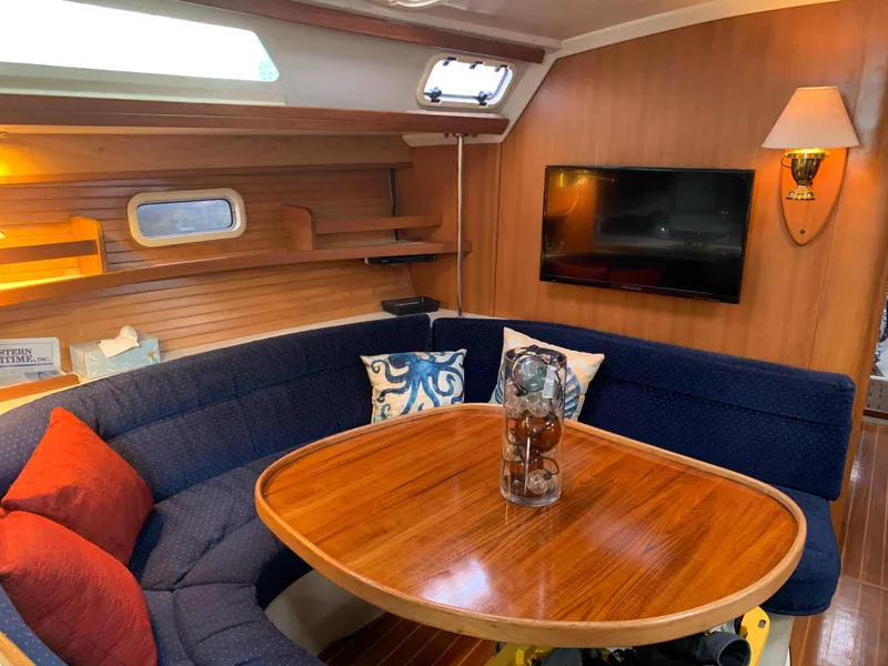 Slide: The Image of Interior of a 1992 Catalina 42 yacht with wooden table and blue upholstery. - 26