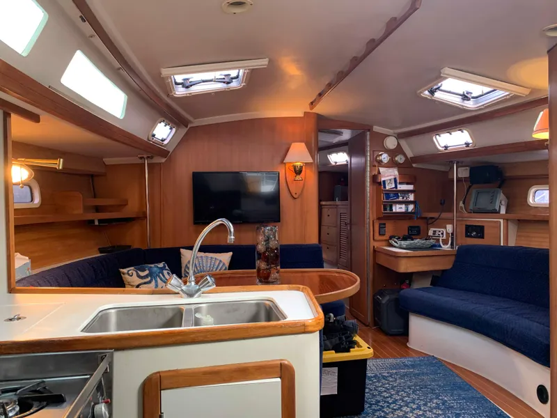 Slide: The Image of Interior of a 1992 Catalina 42 yacht, featuring cozy living area and kitchen. - 27