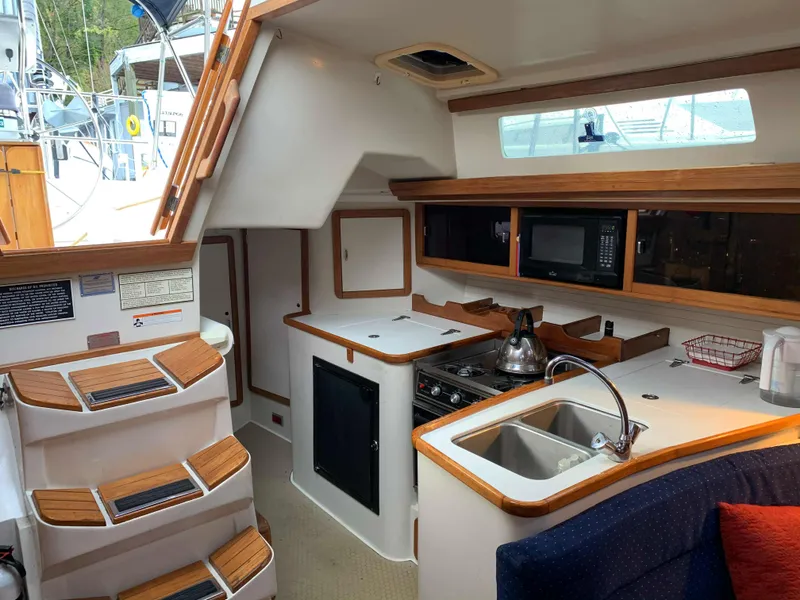 Slide: The Image of Interior of a 1992 Catalina 42 yacht with kitchen and stairs. - 29
