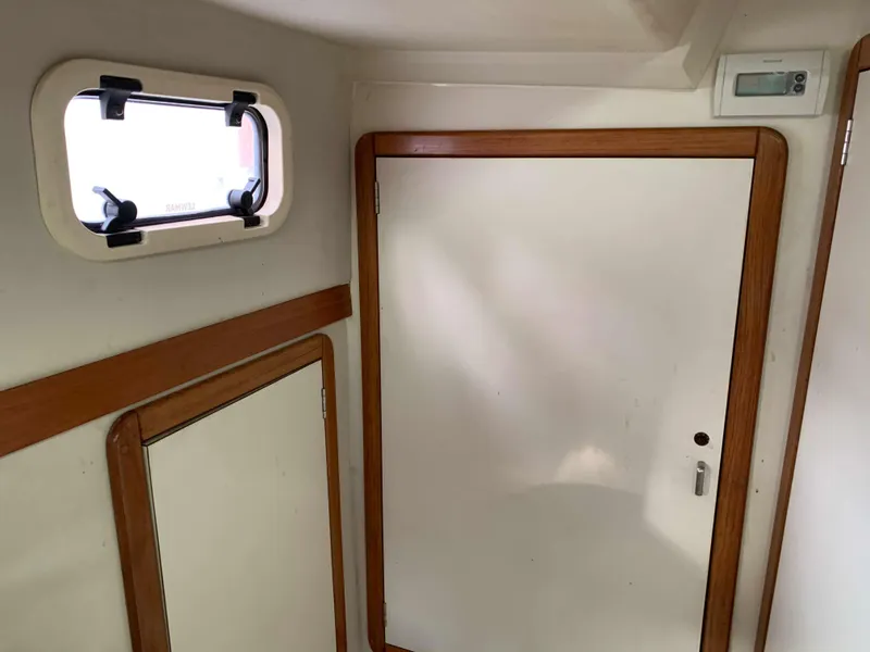 Slide: The Image of Interior of a 1992 Catalina 42 with wooden door and window. - 31