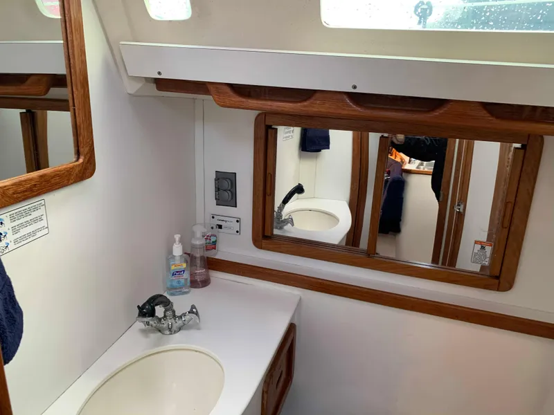 Slide: The Image of Interior of a 1992 Catalina 42 yacht, bathroom with sink and mirror. - 38
