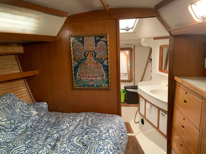Slide: The Image of Interior of a 1992 Catalina 42 yacht with bed and artwork. - 40