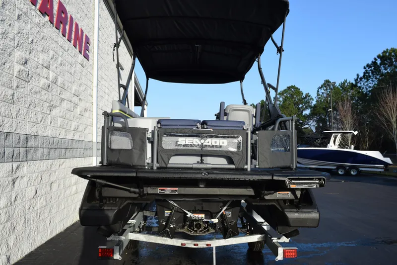 Slide: The Image of 2026 Sea-Doo Switch Cruise Limited 21, rear view, parked near a building. - 5