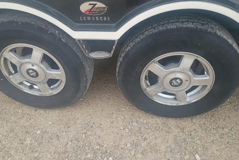 Slide: The Image of 2010 Ranger 520 VX/VS trailer wheels on gravel surface. - 5