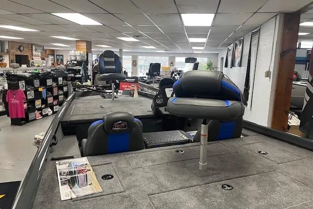 Slide: The Image of 2026 Ranger RT188 boat interior in showroom, featuring seating and storage areas. - 2