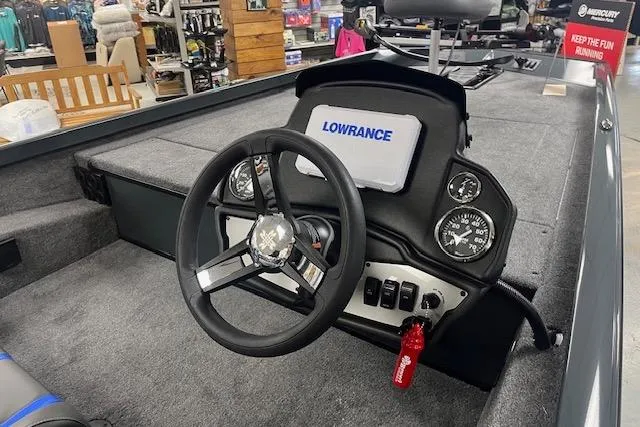 Slide: The Image of 2026 Ranger RT188 boat dashboard with Lowrance display and steering wheel in showroom. - 3