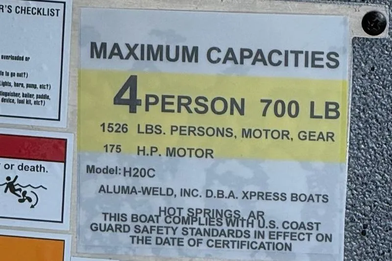 Slide: The Image of 2026 Express H20C boat capacity label: 4 persons, 700 lbs, 175 HP motor. - 11
