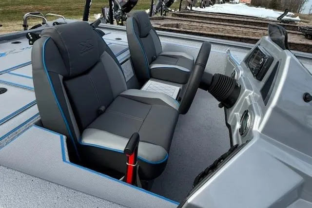 Slide: The Image of 2026 Express H20C boat interior with gray and blue seating, modern dashboard, and steering wheel. - 6