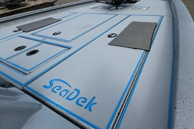 Slide: The Image of 2026 Express H20C boat deck with SeaDek flooring, featuring storage compartments and non-slip surfaces. - 7