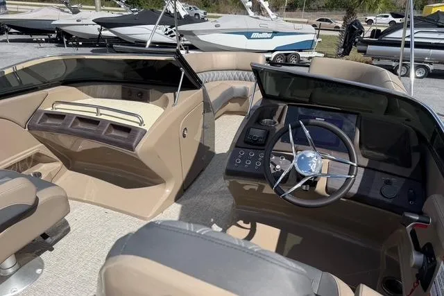 Slide: The Image of 2021 Bennington QX 25 QXSBWA boat interior with modern dashboard and seating. - 12