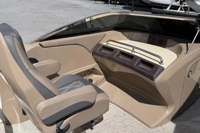 Slide: The Image of 2021 Bennington QX 25 QXSBWA boat interior with beige seating and dashboard. - 13