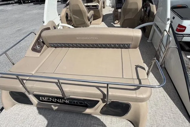 Slide: The Image of 2021 Bennington QX 25 QXSBWA boat interior with beige seating and stainless steel railings. - 17