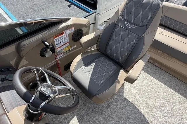 Slide: The Image of Captain's chair and steering wheel of a 2021 Bennington QX 25 QXSBWA boat interior. - 19