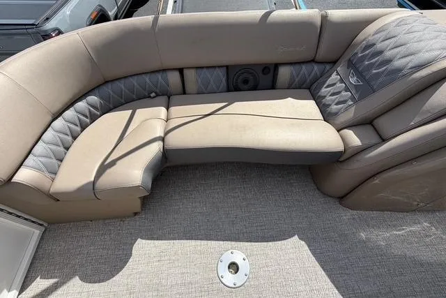 Slide: The Image of 2021 Bennington QX 25 QXSBWA boat interior with beige and gray seating. - 20