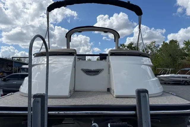 Slide: The Image of 2021 Bennington QX 25 QXSBWA pontoon boat with sleek design under cloudy sky. - 4