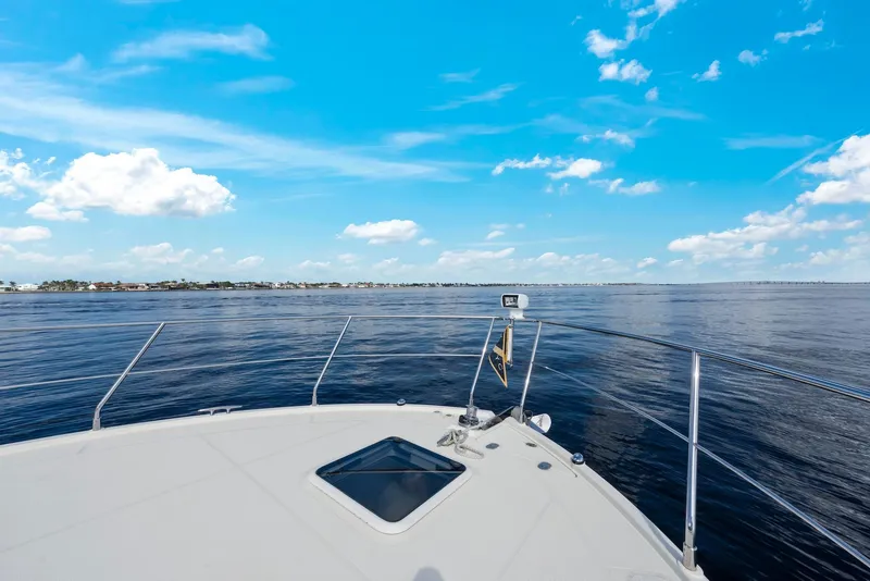Slide: The Image of 2016 Carver C37 Coupe yacht cruising on open water under a clear blue sky. - 10