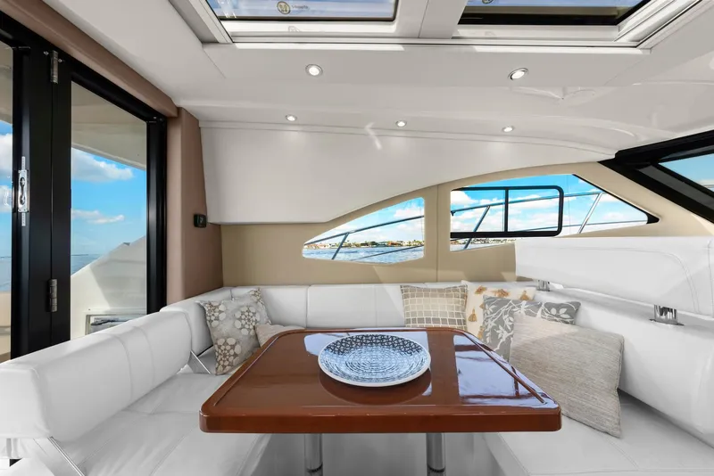 Slide: The Image of Interior of 2016 Carver C37 Coupe yacht with elegant seating and table. - 34