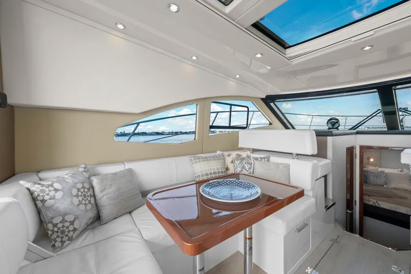 Slide: The Image of Luxurious interior of 2016 Carver C37 Coupe yacht with elegant seating and panoramic windows. - 35