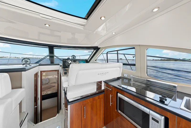 Slide: The Image of Interior of 2016 Carver C37 Coupe yacht with modern kitchen and helm. - 38
