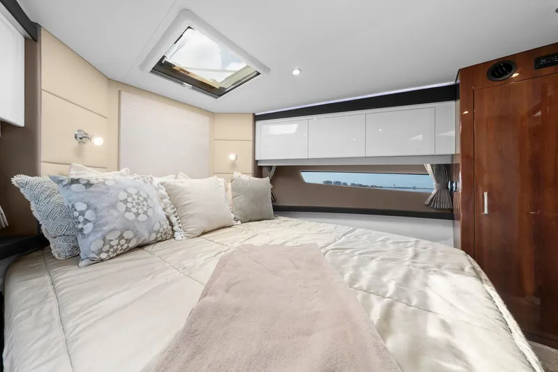 Slide: The Image of Luxurious bedroom interior of 2016 Carver C37 Coupe yacht with skylight and elegant bedding. - 48