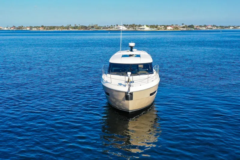 Slide: The Image of 2016 Carver C37 Coupe yacht on calm blue water, front view. - 5
