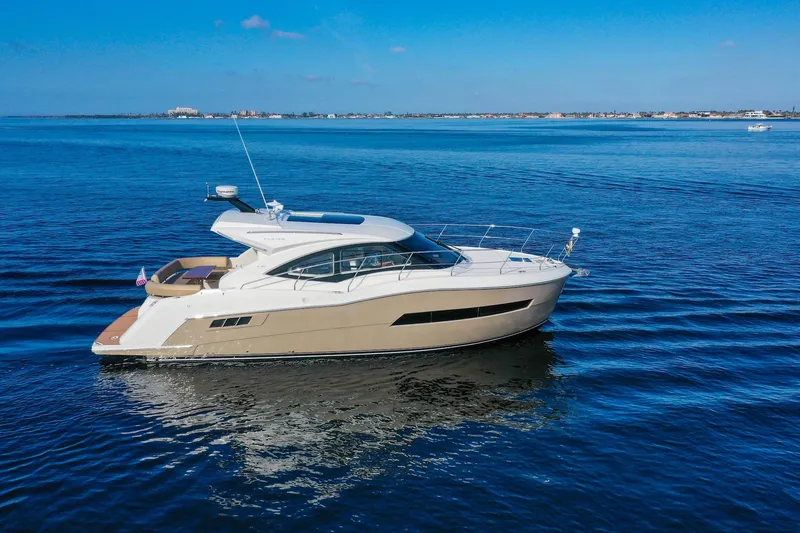 Slide: The Image of 2016 Carver C37 Coupe yacht cruising on calm blue waters. - 6