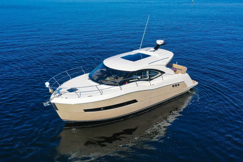 Slide: The Image of 2016 Carver C37 Coupe yacht cruising on open water. - 7