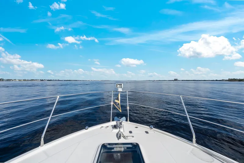 Slide: The Image of Bow view from 2016 Carver C37 Coupe yacht on open water under blue sky. - 9