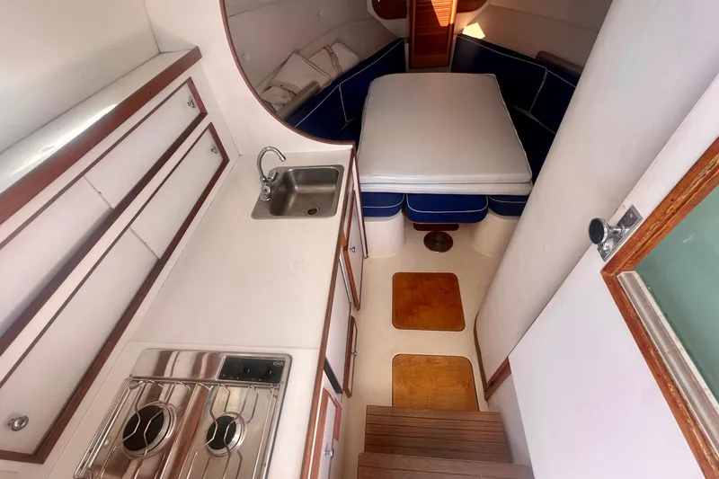 Slide: The Image of Interior of 1985 Bertram 28 Bahia Mar boat with kitchenette and sleeping area. - 5