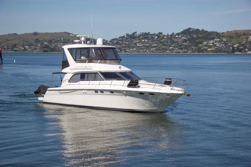 The Image of 1998 Sea Ray 480 Sedan Bridge yacht cruising on calm waters. - 0