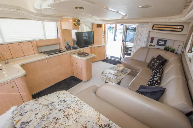 Slide: The Image of Luxurious interior of 1998 Sea Ray 480 Sedan Bridge yacht with modern furnishings. - 14