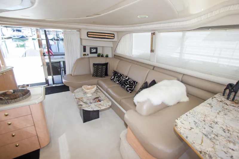 Slide: The Image of Luxurious interior of 1998 Sea Ray 480 Sedan Bridge yacht with elegant seating and decor. - 15