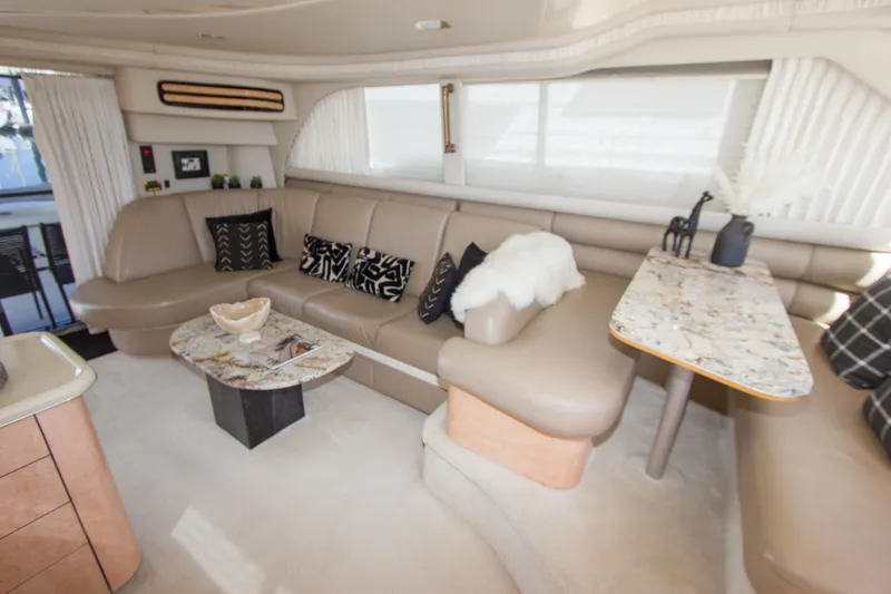 Slide: The Image of Luxurious interior of 1998 Sea Ray 480 Sedan Bridge with elegant seating and decor. - 16