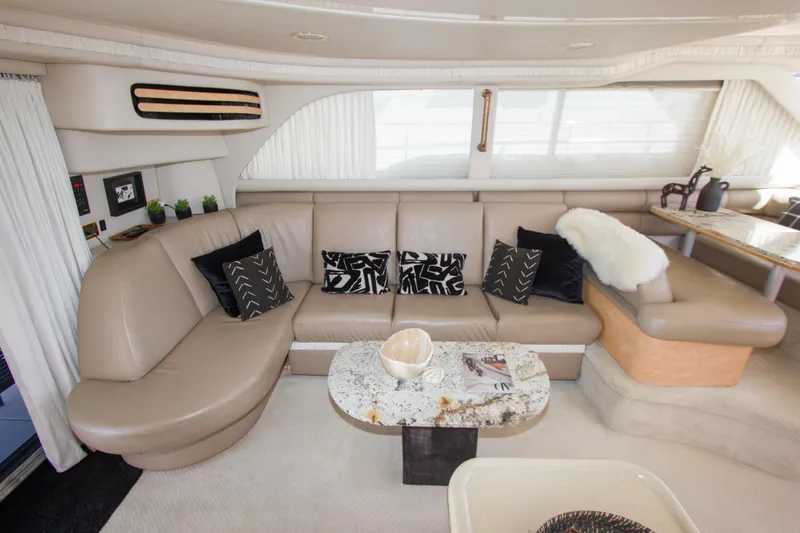 Slide: The Image of Luxurious interior of a 1998 Sea Ray 480 Sedan Bridge yacht with elegant seating and decor. - 17