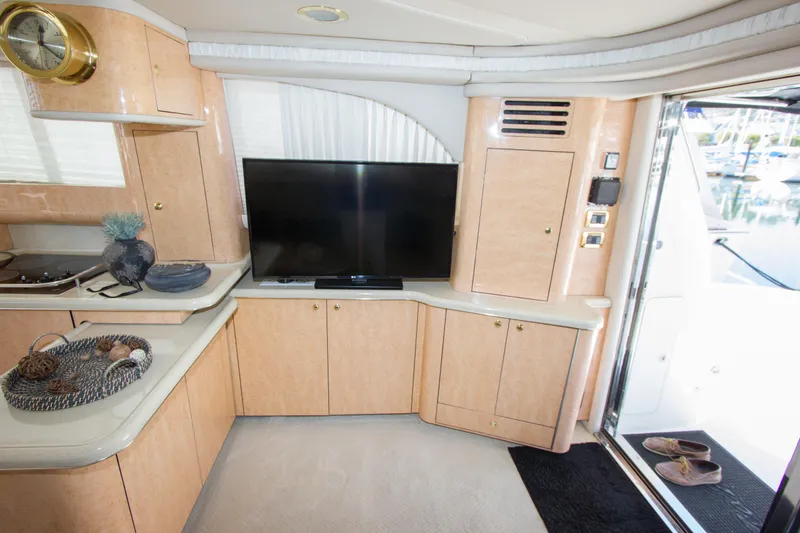 Slide: The Image of Interior of 1998 Sea Ray 480 Sedan Bridge with TV and decor. - 18