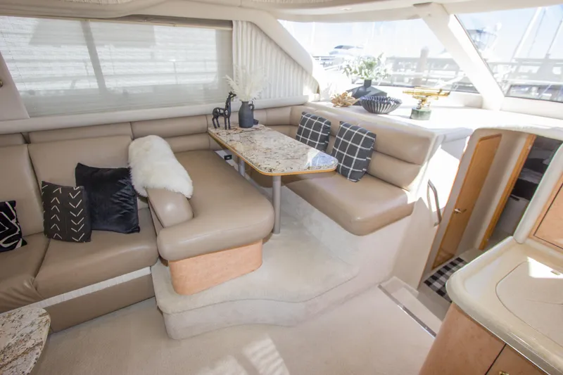 Slide: The Image of Luxurious interior of a 1998 Sea Ray 480 Sedan Bridge yacht with elegant seating and decor. - 19