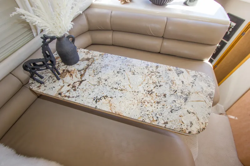 Slide: The Image of Luxurious interior of 1998 Sea Ray 480 Sedan Bridge with elegant marble table and decor. - 20
