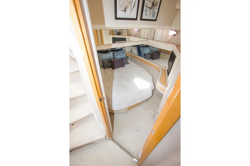 Slide: The Image of Interior cabin of 1998 Sea Ray 480 Sedan Bridge with cozy bed and decor. - 23