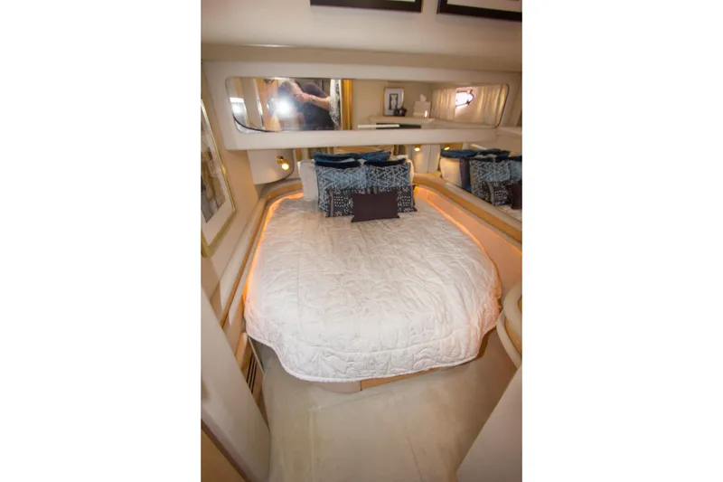 Slide: The Image of 1998 Sea Ray 480 Sedan Bridge bedroom with cozy bedding and elegant decor. - 24