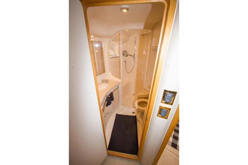 Slide: The Image of Bathroom interior of 1998 Sea Ray 480 Sedan Bridge yacht, featuring shower and sink. - 28