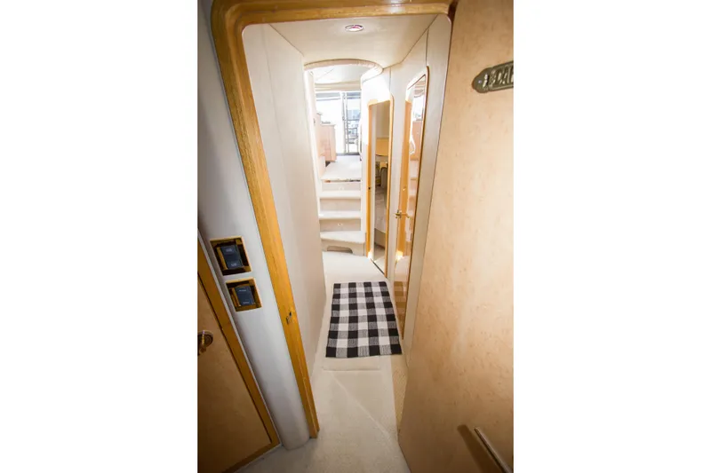Slide: The Image of Interior hallway of 1998 Sea Ray 480 Sedan Bridge yacht with checkered rug. - 29