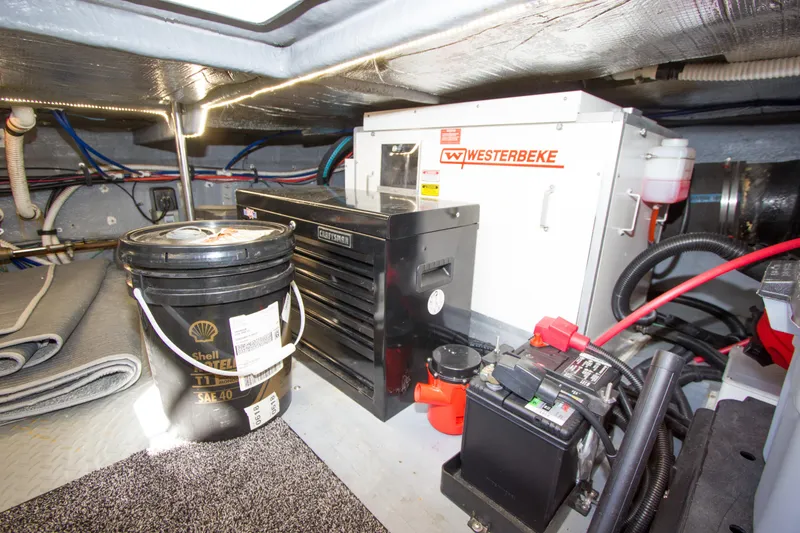 Slide: The Image of Engine room of 1998 Sea Ray 480 Sedan Bridge with Westerbeke generator and tools. - 35