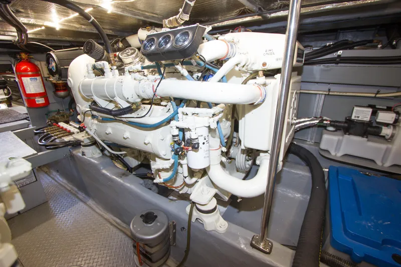 Slide: The Image of Engine room of 1998 Sea Ray 480 Sedan Bridge with visible machinery and fire extinguisher. - 37
