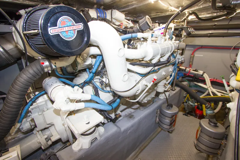 Slide: The Image of Engine room of a 1998 Sea Ray 480 Sedan Bridge yacht, featuring complex machinery. - 40