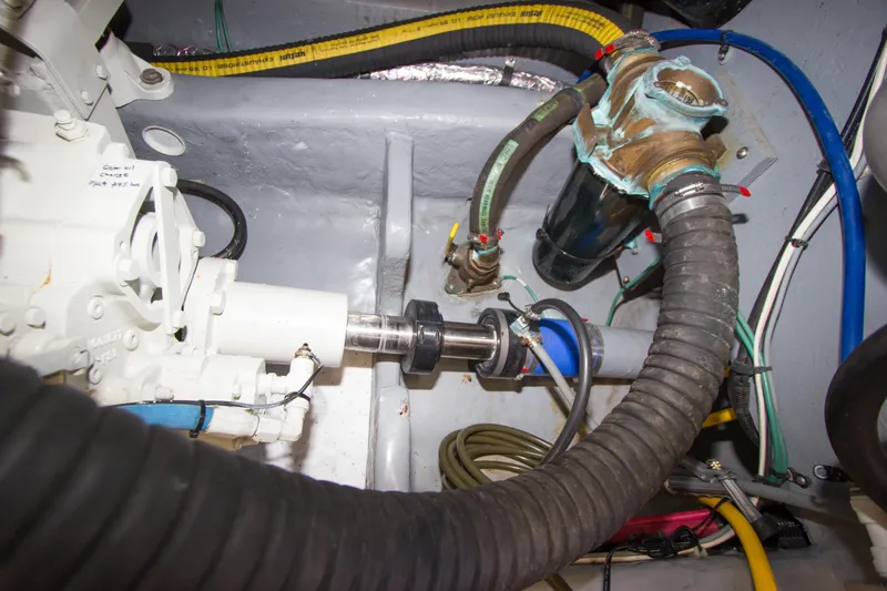 Slide: The Image of Engine compartment of 1998 Sea Ray 480 Sedan Bridge with visible hoses and components. - 41